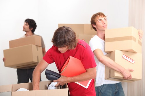 Movers handling furniture in Roehampton storage facility